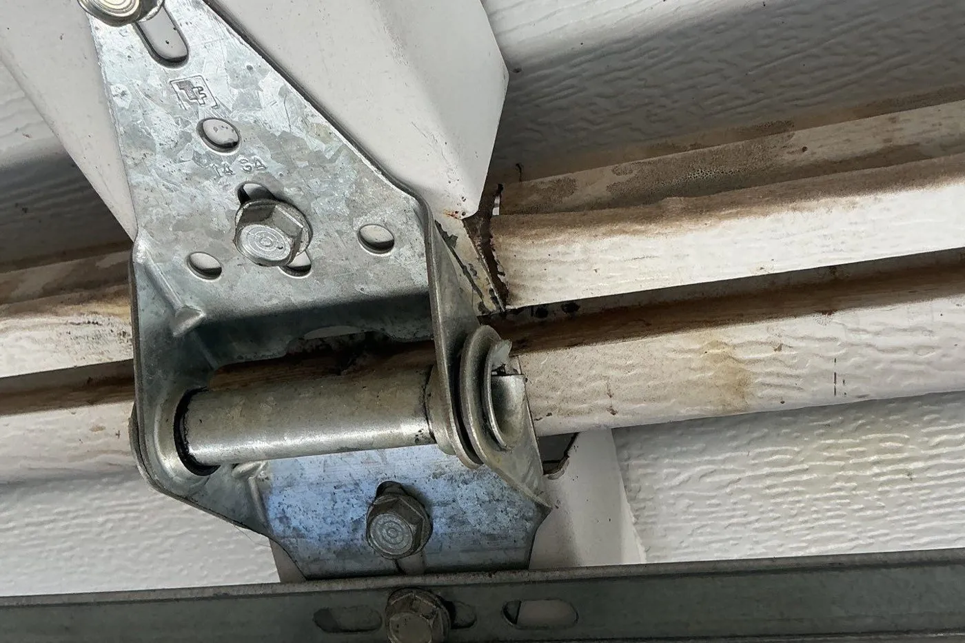Galvanized hinge and roller where two garage door sections meet