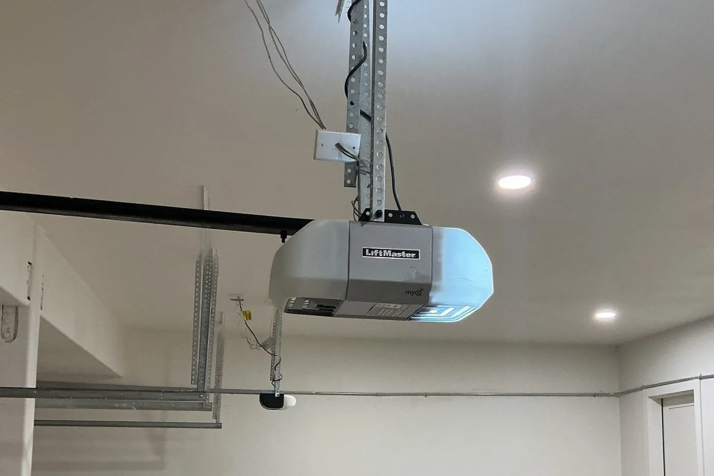 LiftMaster opener on its rail in a finished garage with an epoxy floor