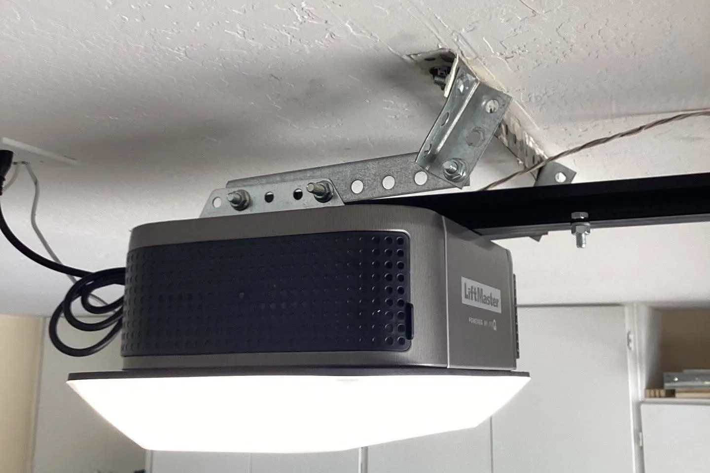 LiftMaster garage door opener with a built-in light mounted to a garage ceiling