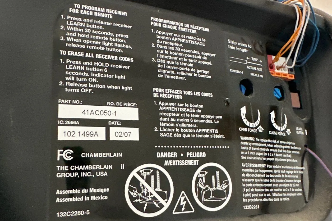 Opener motor head with its programming label and wiring terminals